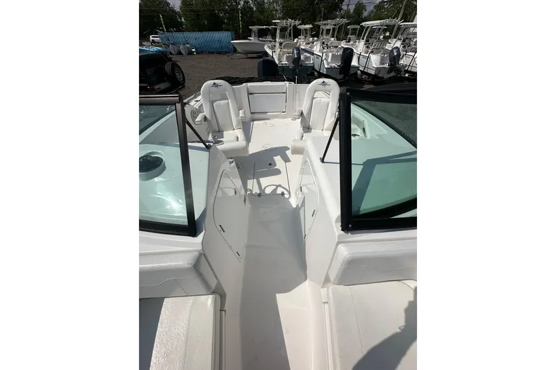 Slide: The Image of 2024 Aquasport 2200 Dual Console boat interior with seating and open deck view. - 16