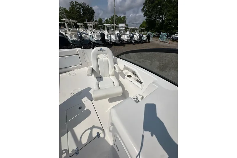 Slide: The Image of 2024 Aquasport 2200 Dual Console boat interior with seating and steering wheel. - 18