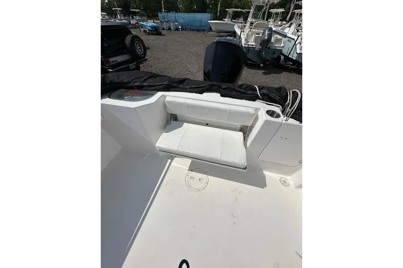 Slide: The Image of 2024 Aquasport 2200 Dual Console boat interior with foldable seat and storage. - 20