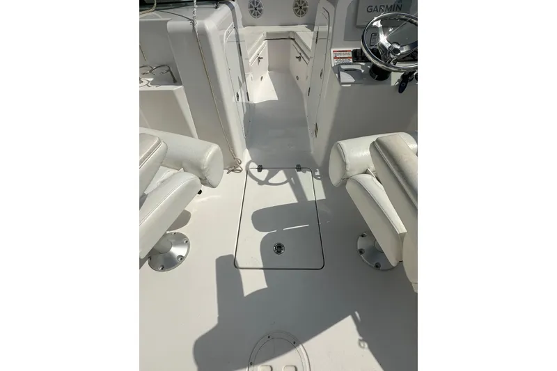 Slide: The Image of 2024 Aquasport 2200 Dual Console interior with seating and steering wheel. - 26