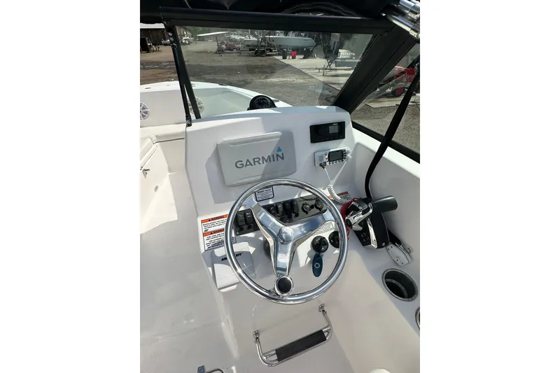 Slide: The Image of 2024 Aquasport 2200 Dual Console boat dashboard with Garmin navigation system. - 28