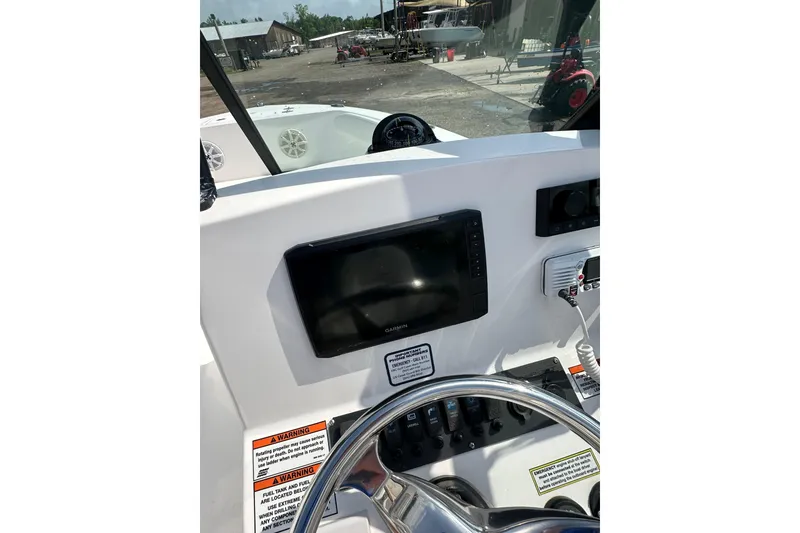 Slide: The Image of 2024 Aquasport 2200 Dual Console dashboard with steering wheel and electronic controls. - 29