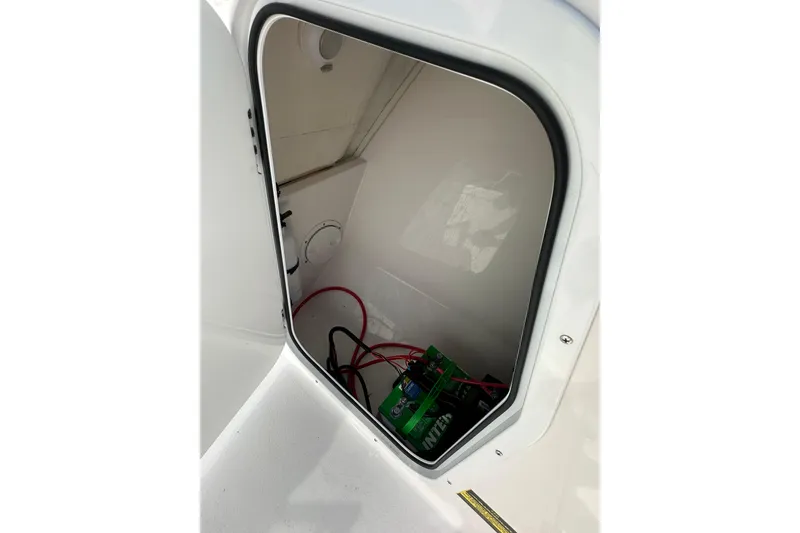 Slide: The Image of 2024 Aquasport 2200 Dual Console battery compartment with wiring visible. - 35