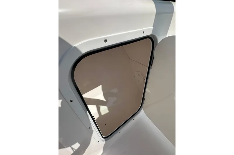 Slide: The Image of 2024 Aquasport 2200 Dual Console storage compartment with open hatch. - 36