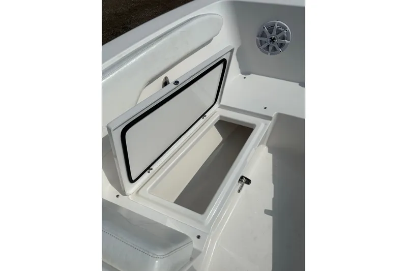 Slide: The Image of 2024 Aquasport 2200 Dual Console boat storage compartment with open hatch and speaker. - 37