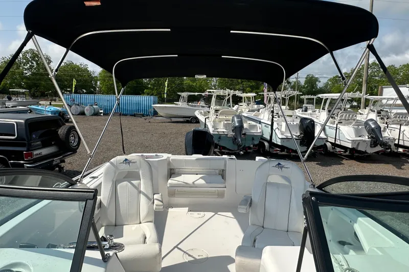 Slide: The Image of 2024 Aquasport 2200 Dual Console boat with canopy, parked in a marina. - 39
