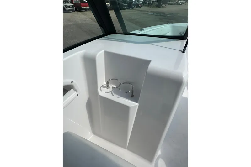 Slide: The Image of 2024 Aquasport 2200 Dual Console boat interior with cup holders. - 40