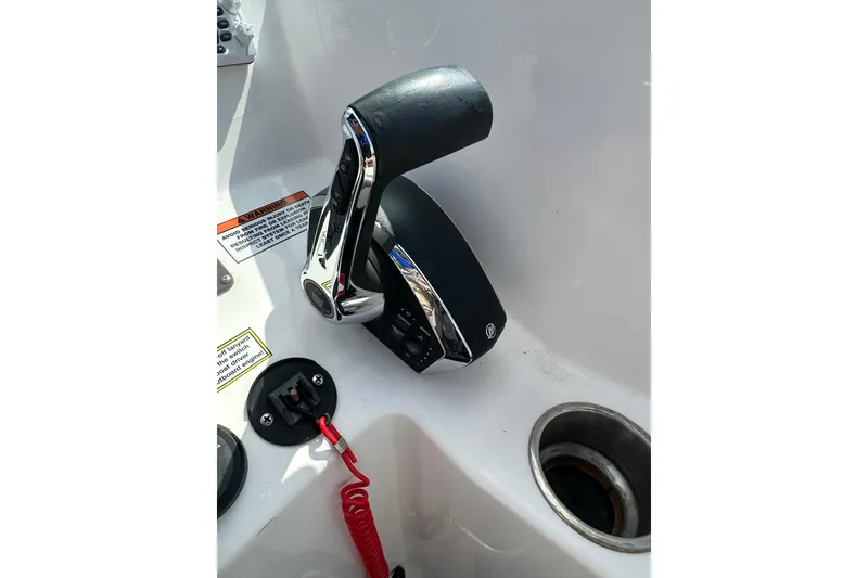 Slide: The Image of Throttle control of 2024 Aquasport 2200 Dual Console boat, featuring sleek design and safety features. - 42