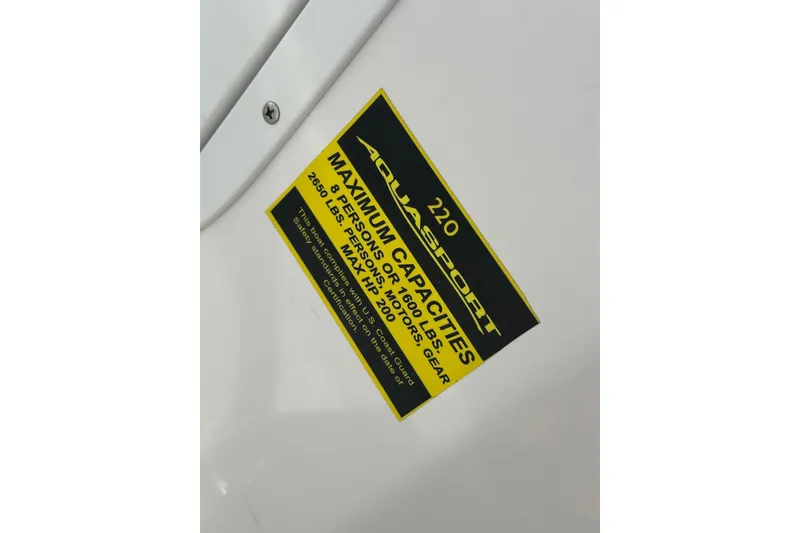 Slide: The Image of 2024 Aquasport 2200 Dual Console capacity label detailing maximum weight and passenger limits. - 46