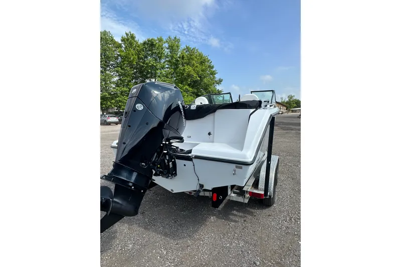 Slide: The Image of 2024 Aquasport 2200 Dual Console boat with powerful outboard motor on trailer. - 5