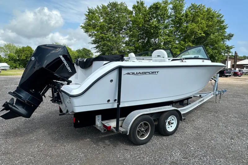 Slide: The Image of 2024 Aquasport 2200 Dual Console boat on trailer with Mercury outboard motor. - 6