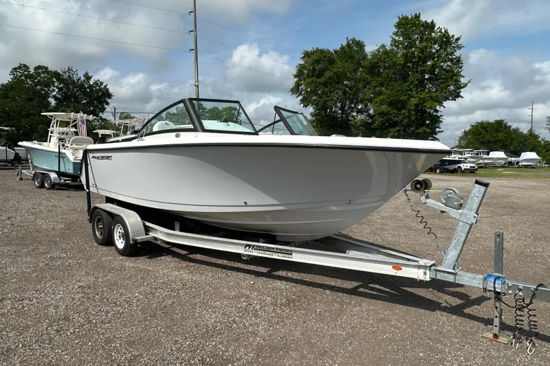Slide: The Image of 2024 Aquasport 2200 Dual Console boat on trailer, parked outdoors. - 9