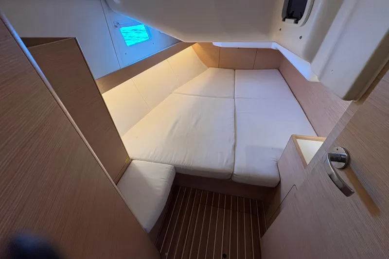 Slide: The Image of Cozy cabin interior of 2018 Elan Impression yacht with wooden finish and comfortable bedding. - 11
