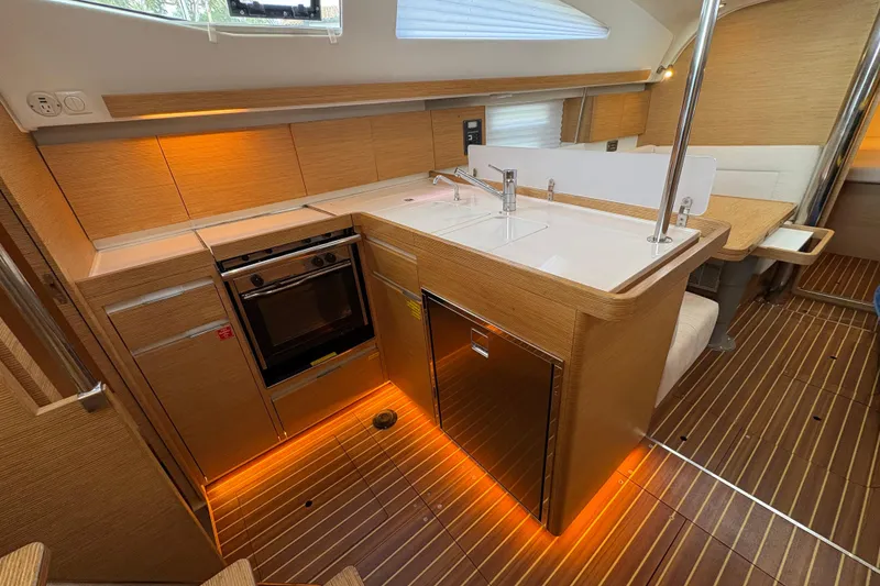 Slide: The Image of Modern 2018 Elan Impression yacht kitchen with wood finish and ambient lighting. - 15