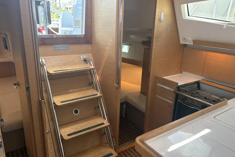 Slide: The Image of Interior of 2018 Elan Impression yacht with wooden stairs and compact kitchen. - 16