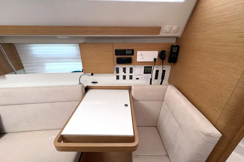 Slide: The Image of 2018 Elan Impression yacht interior with control panel and seating area. - 18