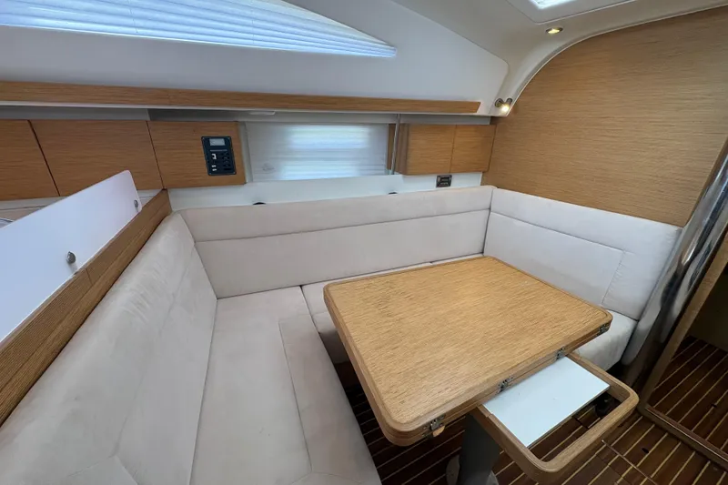 Slide: The Image of Cozy interior of 2018 Elan Impression yacht with wooden table and cushioned seating. - 22