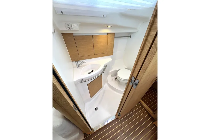 Slide: The Image of Compact bathroom in 2018 Elan Impression yacht with wooden cabinetry and modern fixtures. - 25