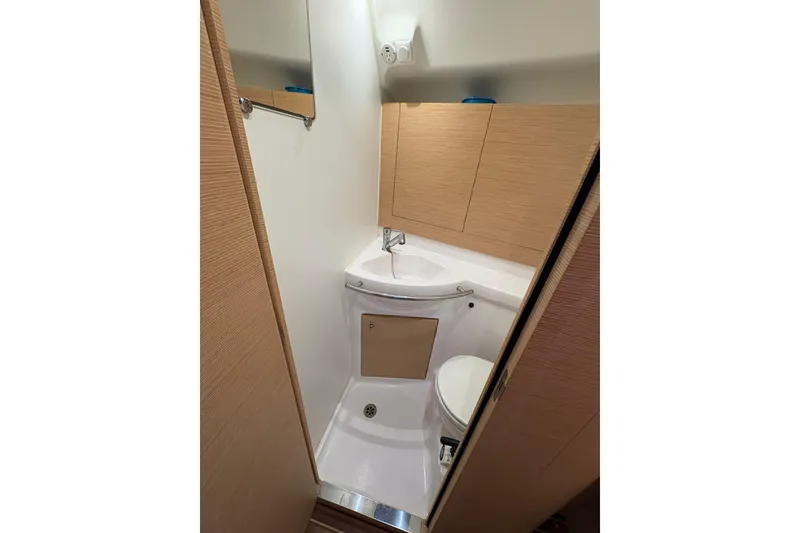 Slide: The Image of Compact bathroom in 2018 Elan Impression yacht with modern fixtures and wooden cabinetry. - 26