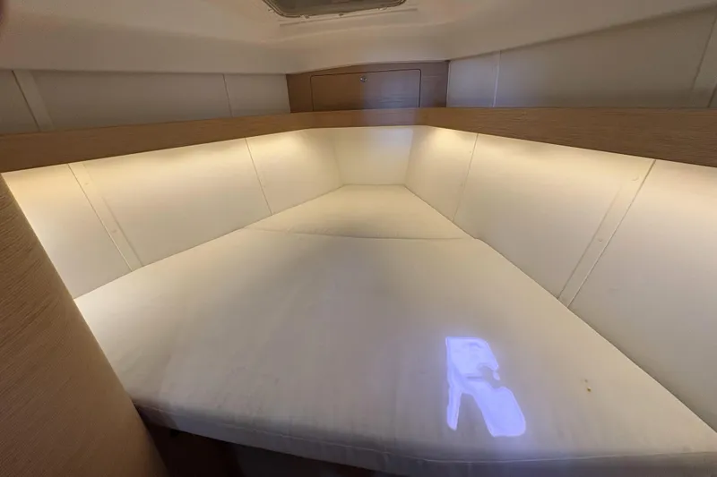 Slide: The Image of Cozy cabin interior of 2018 Elan Impression yacht with soft lighting and comfortable bedding. - 27