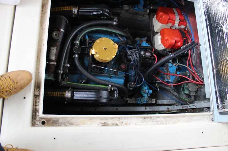 Slide: The Image of Engine compartment of a 1980 Carver 280 Voyager boat, showing mechanical components and wiring. - 11