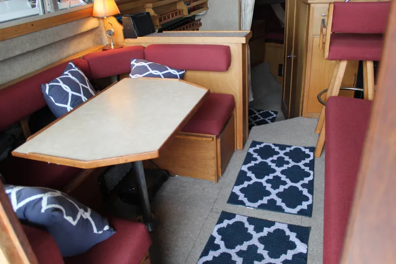 Slide: The Image of Interior of 1980 Carver 280 Voyager boat with cozy seating and nautical decor. - 13