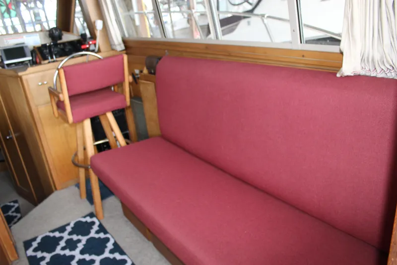 Slide: The Image of Interior of 1980 Carver 280 Voyager with maroon seating and wooden accents. - 14