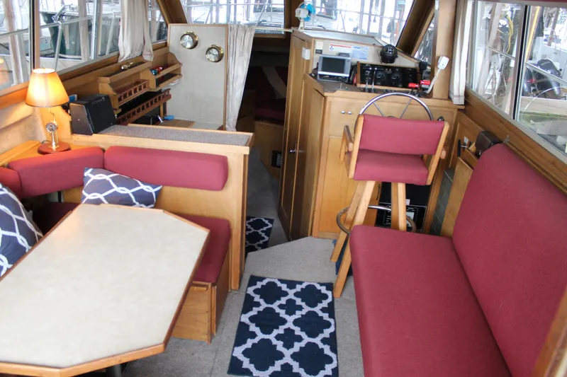Slide: The Image of Interior of 1980 Carver 280 Voyager boat with red seating and wooden accents. - 15