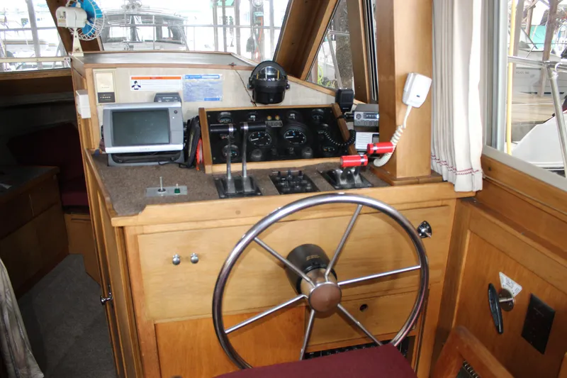 Slide: The Image of Interior helm of a 1980 Carver 280 Voyager boat with steering wheel and navigation equipment. - 16