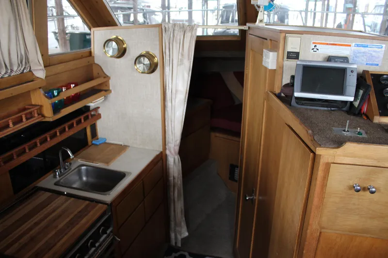 Slide: The Image of Interior of 1980 Carver 280 Voyager boat with kitchenette and navigation equipment. - 18
