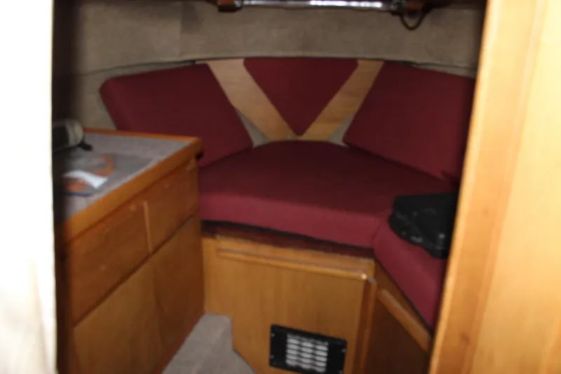 Slide: The Image of Interior cabin of 1980 Carver 280 Voyager with red cushions and wooden cabinetry. - 19