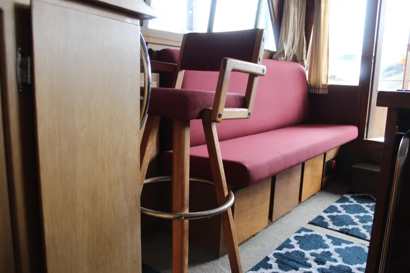 Slide: The Image of Interior of 1980 Carver 280 Voyager with red seating and wooden furniture. - 21