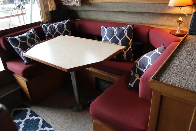 Slide: The Image of Interior of 1980 Carver 280 Voyager with red seating and nautical-themed pillows. - 23