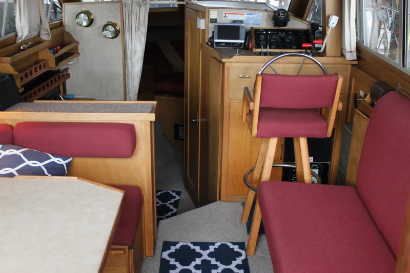 Slide: The Image of Interior of 1980 Carver 280 Voyager boat with red seating and wooden accents. - 24