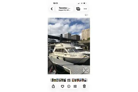 Slide: The Image of 1980 Carver 280 Voyager docked in Tacoma marina with cityscape background. - 25