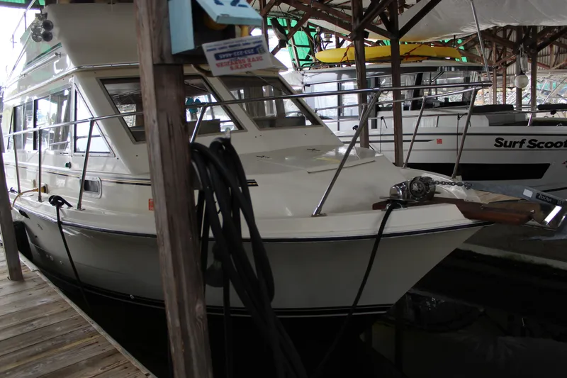 Slide: The Image of 1980 Carver 280 Voyager docked in a marina, side view. - 3