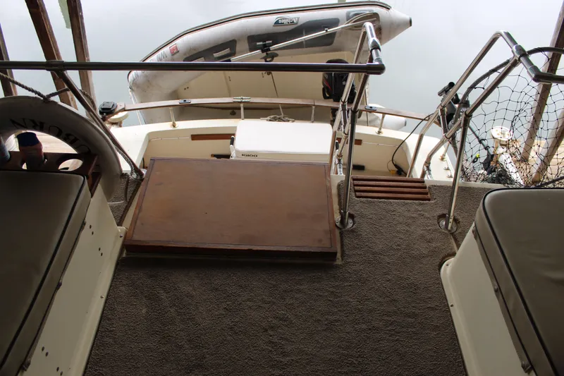 Slide: The Image of 1980 Carver 280 Voyager boat interior with seating and railing, overlooking water. - 8
