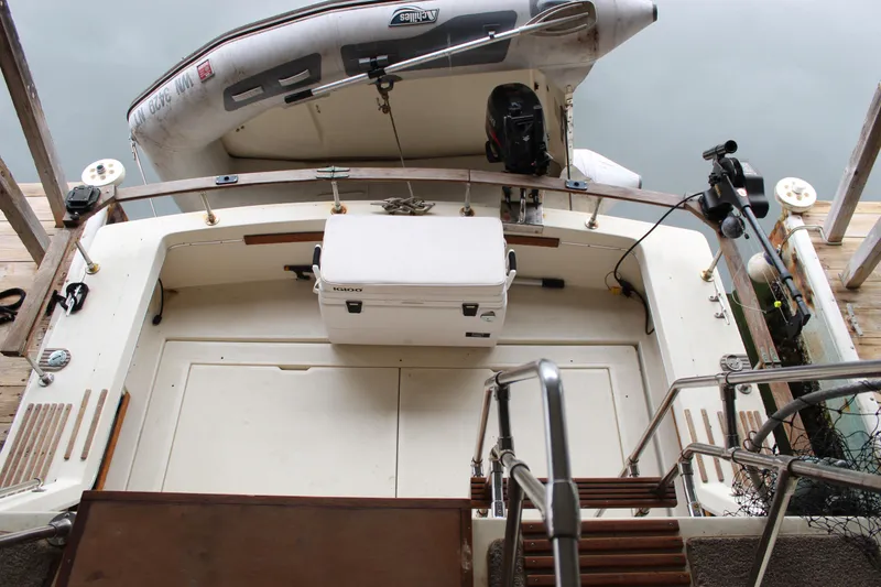 Slide: The Image of 1980 Carver 280 Voyager boat deck with cooler and inflatable dinghy. - 9