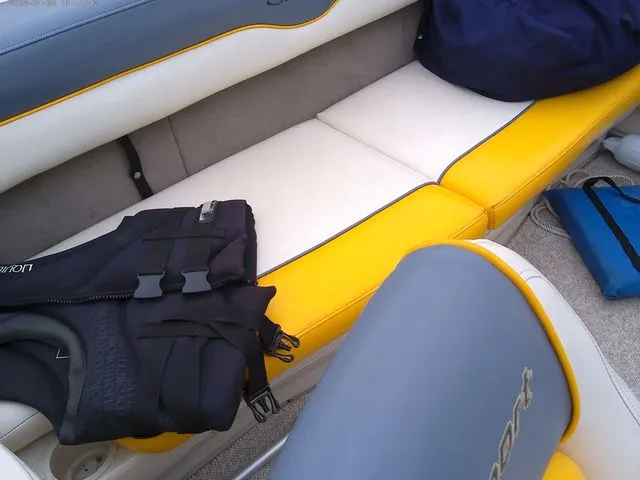Slide: The Image of Interior of a 2007 Sea Ray 205 boat with yellow and white seating. - 5