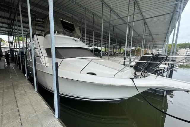 The Image of 1998 Silverton 372 Motor Yacht docked in a covered marina. - 0