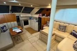 Slide: The Image of Interior of 1998 Silverton 372 Motor Yacht with seating and kitchenette. - 13