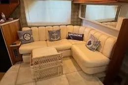 Slide: The Image of Luxurious interior of 1998 Silverton 372 Motor Yacht with cozy seating and nautical-themed pillows. - 15
