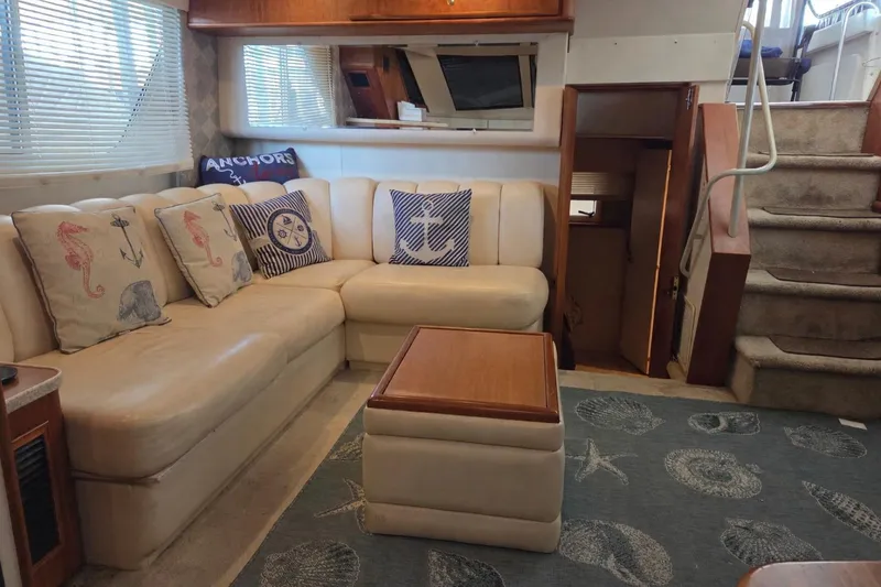 Slide: The Image of Interior of 1998 Silverton 372 Motor Yacht with cozy seating and nautical decor. - 17