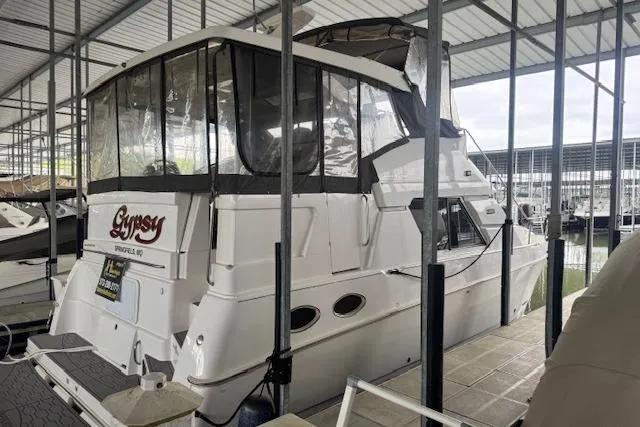 Slide: The Image of 1998 Silverton 372 Motor Yacht docked in a covered marina. - 2