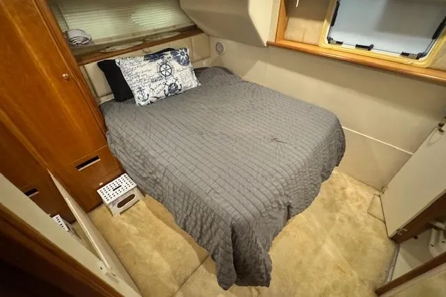 Slide: The Image of Cozy bedroom in 1998 Silverton 372 Motor Yacht with nautical-themed decor. - 28