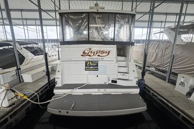Slide: The Image of 1998 Silverton 372 Motor Yacht docked, rear view with "Gypsy" name visible. - 3