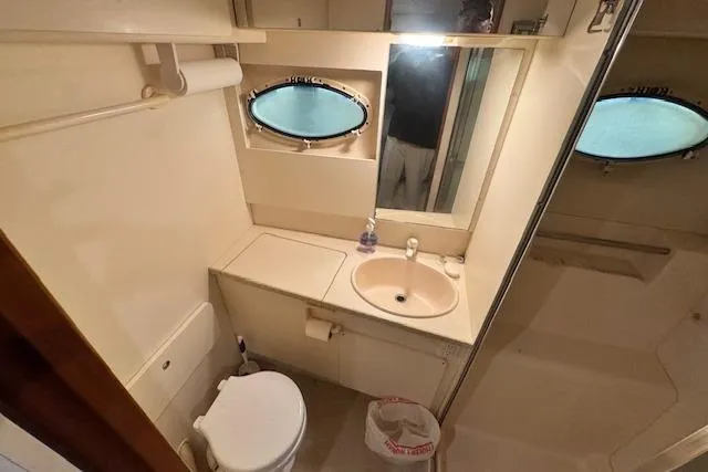 Slide: The Image of Bathroom interior of 1998 Silverton 372 Motor Yacht with sink, toilet, and mirror. - 30