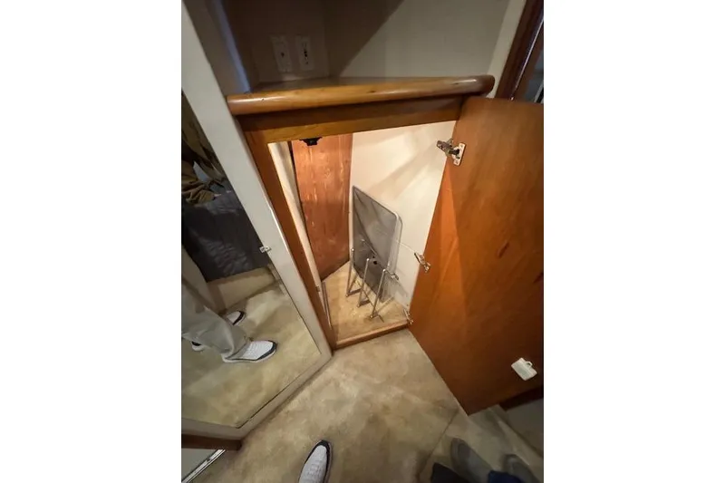 Slide: The Image of Interior storage space in a 1998 Silverton 372 Motor Yacht, featuring wooden cabinetry. - 31