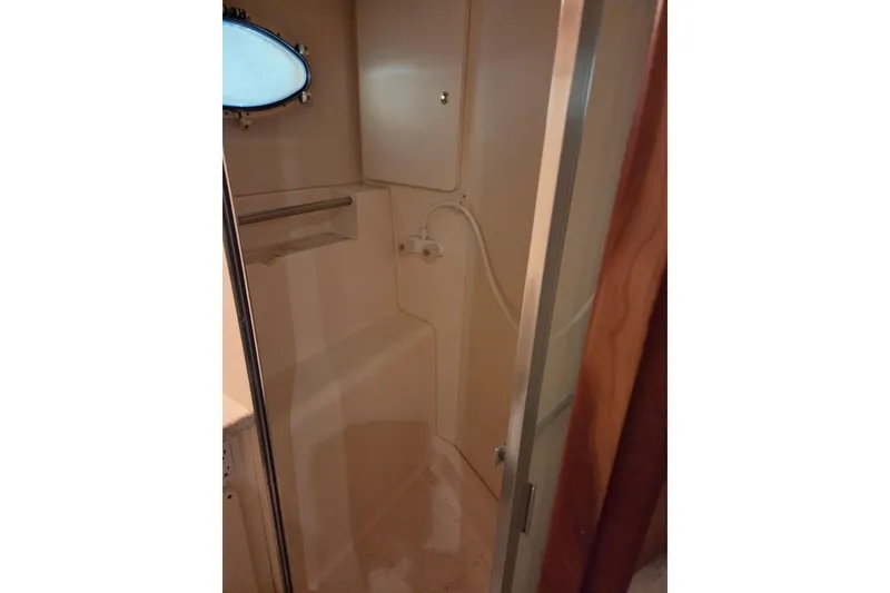 Slide: The Image of 1998 Silverton 372 Motor Yacht bathroom with shower and storage cabinet. - 33