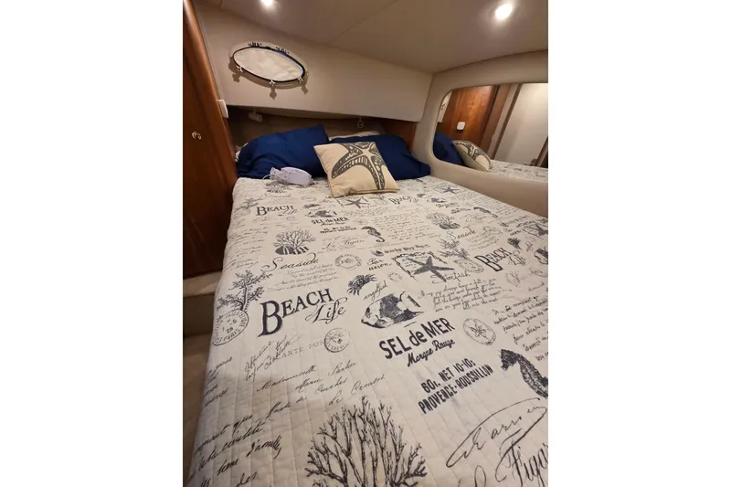 Slide: The Image of Cozy bedroom in 1998 Silverton 372 Motor Yacht with nautical-themed bedding. - 34